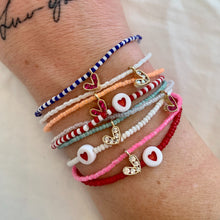 Load image into Gallery viewer, multi colored seed bead bracelet with a gold plated heart charm with clear cz crystal stones