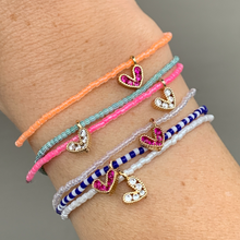 Load image into Gallery viewer, multi colored seed bead bracelet with a gold plated heart charm with clear cz crystal stones
