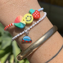 Load image into Gallery viewer, blue, white and red patterned seed bead bracelet with a strawberry, smiley face and multi colored heart bead and ufo enamel sterling silver bracelet

