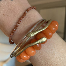 Load image into Gallery viewer, faceted orange glass bead stretch bracelet
