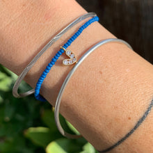 Load image into Gallery viewer, blue seed bead bracelet with a gold plated heart charm with clear cz crystal stones
