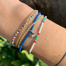 Load image into Gallery viewer, blue seed bead bracelet with a gold plated heart charm with clear cz crystal stones