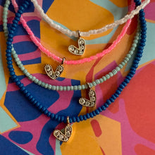 Load image into Gallery viewer, multi colored seed bead bracelet with a gold plated heart charm with clear cz stones