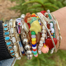 Load image into Gallery viewer, multi colored mini pony bead bracelet with a ceramic toucan bead

