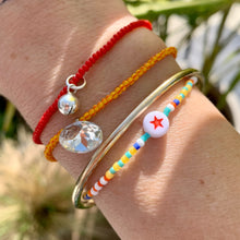Load image into Gallery viewer, white, orange, blue, turquoise, yellow seed bead elastic bracelet with red star bead
