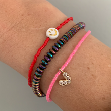 Load image into Gallery viewer, multi colored seed bead bracelet with a gold plated heart charm with clear cz crystal stones