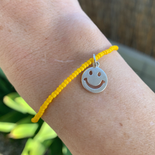 Load image into Gallery viewer, yellow seed bead bracelet with a fun sterling silver smiley face charm 
