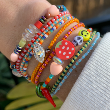 Load image into Gallery viewer, red, orange and turquoise seed bead bracelet with a peach heart, round strawberry, skull, smiley and a glass chili pepper
