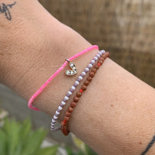 Load image into Gallery viewer, neon pink seed bead bracelet with a gold plated heart charm with clear cz crystal stones
