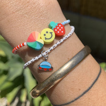 Load image into Gallery viewer, blue, white and red patterned seed bead bracelet with a strawberry, smiley face and multi colored heart bead and ufo enamel sterling silver bracelet
