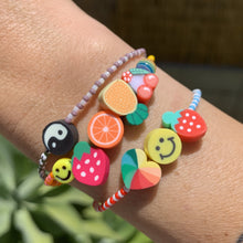 Load image into Gallery viewer, blue, white and red patterned seed bead bracelet with a strawberry, smiley face and multi colored heart bead and tropical fruit and ying yang bracelets
