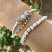Load image into Gallery viewer, white seed bead bracelet with three multi colored striped beach ball beads
