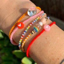 Load image into Gallery viewer, neon pink seed bead bracelet with red heart bead. red seed bead bracelet with pink heart bead. and rainbow bracelets
