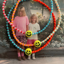 Load image into Gallery viewer, multi colored and patterned seed bead bracelet with a yellow smiley face bead
