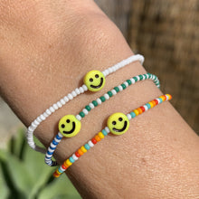 Load image into Gallery viewer, multi colored, patterned seed bead bracelet with a yellow smiley face bead
