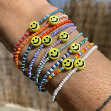 Load image into Gallery viewer, multi colored patterned striped colorful seed bead stretchy bracelet with yellow smiley face
