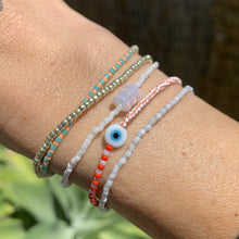 Load image into Gallery viewer, red, white luster, white and red striped seed bead bracelet with a glass evil eye bead
