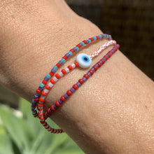 Load image into Gallery viewer, red, white luster, white and red striped seed bead bracelet with a glass evil eye bead
