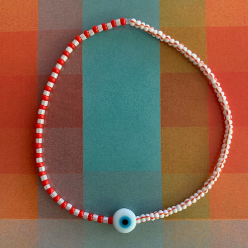 red, white luster, white and red striped seed bead bracelet with a glass evil eye bead
