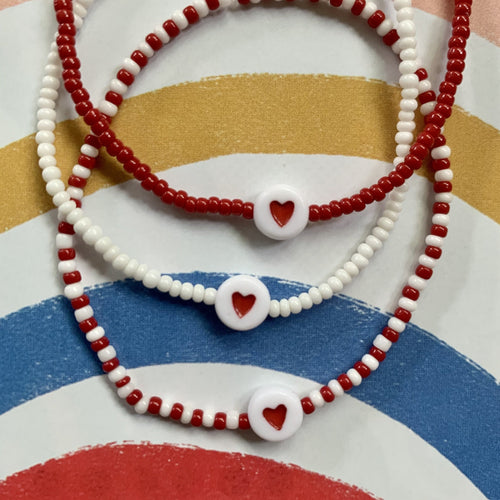 red and white seed bead stretchy bracelet with red heart bead