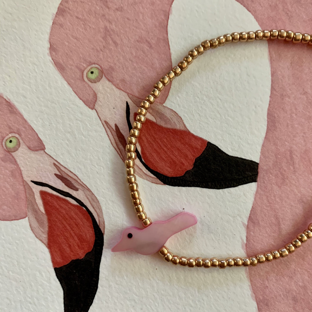rose gold colored seed beads with a pink bird bead