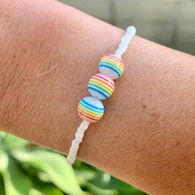Load image into Gallery viewer, white seed bead elastic bracelet with colorful striped ball beads
