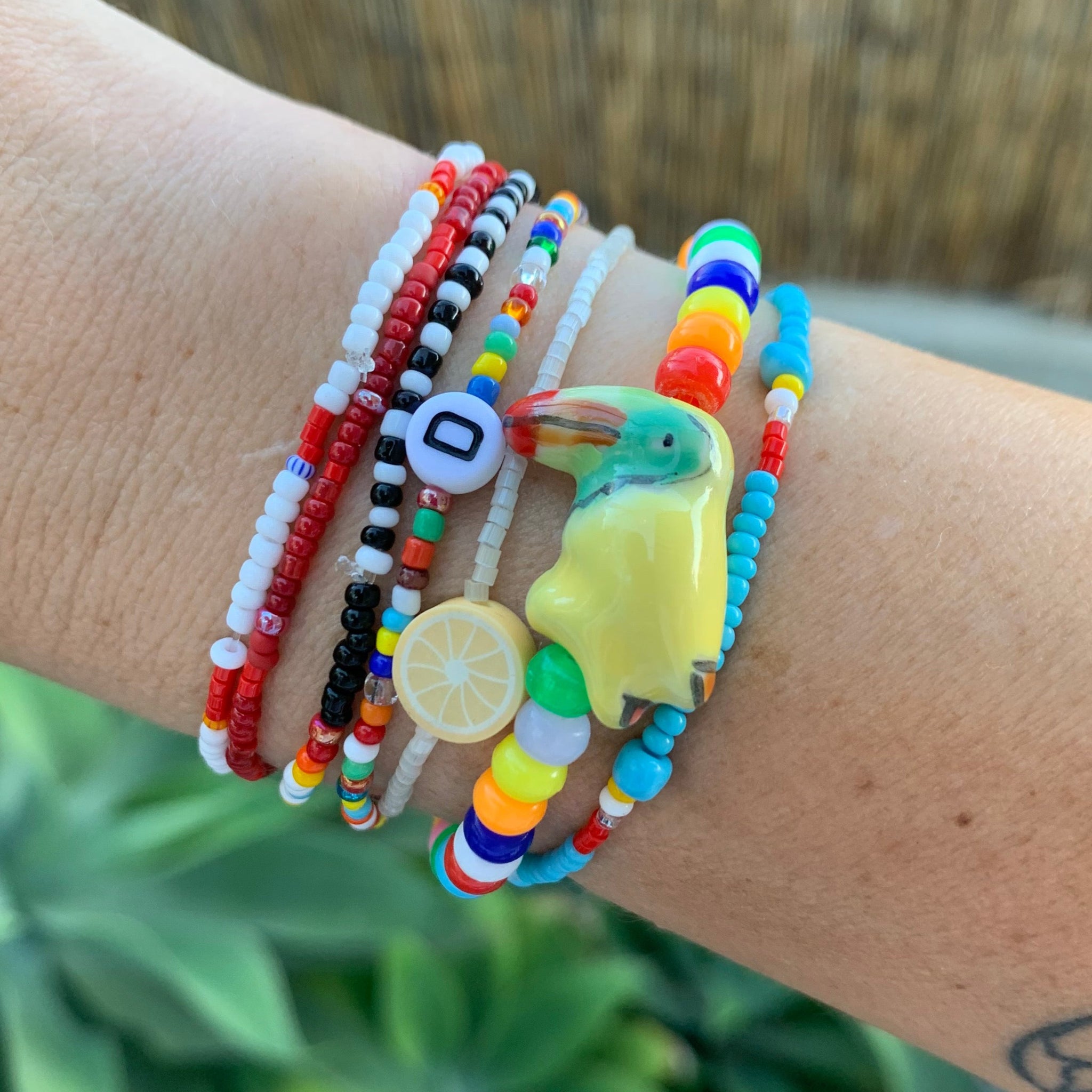 multi colored mini pony bead bracelet with ceramic toucan bead